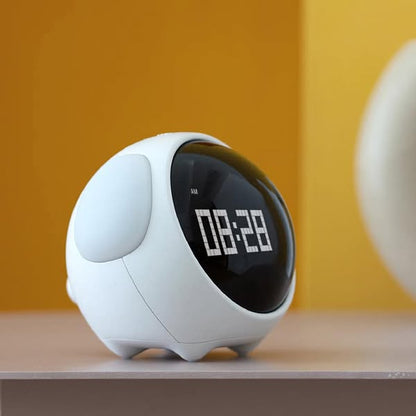Digital alarm emoji clock which has ears as light and comes with white body, displays time, temperature. Responds with voice and movement.